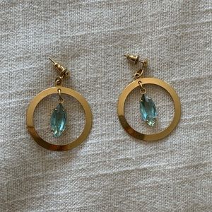 Gold circle dangle earrings with blue gem